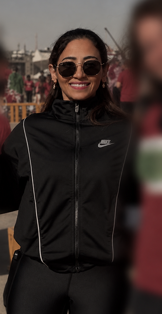 Your coach, smiling outdoors